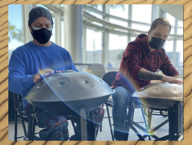 Two men playing handpan