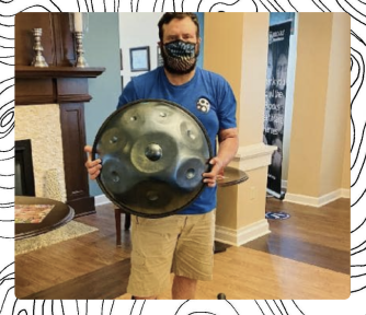 An artist holding his handpan