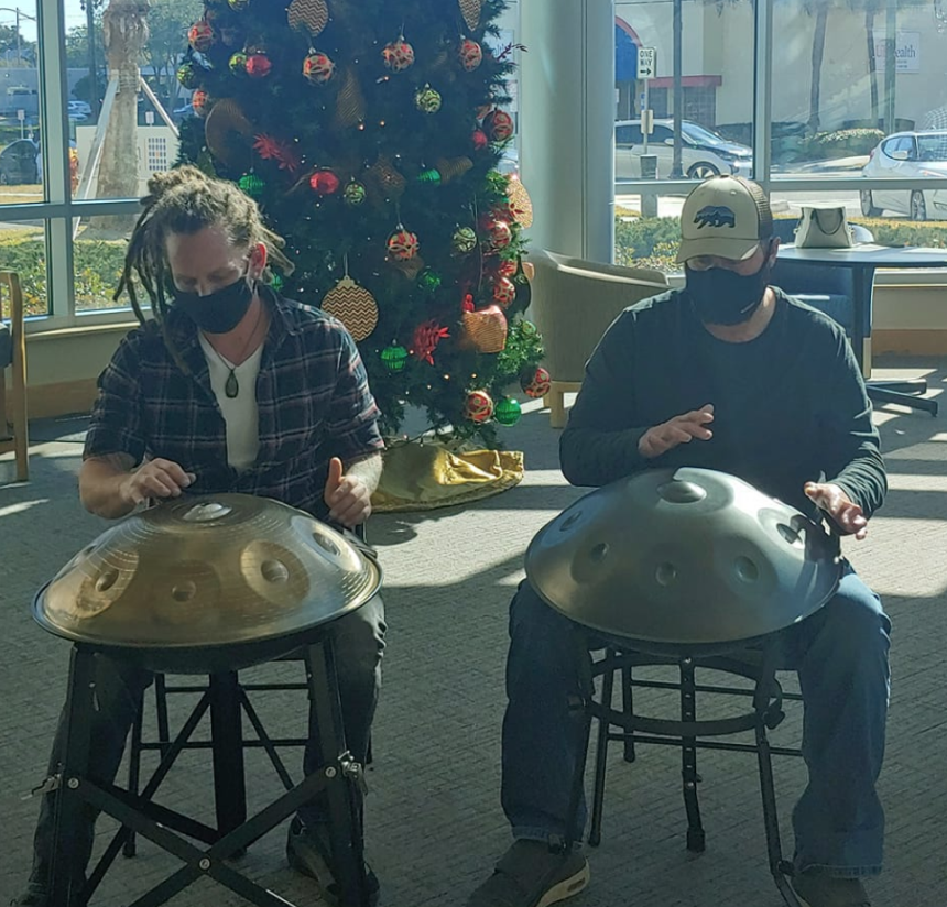 Two people playing handpan at Christmastime