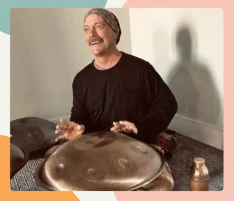 An artist playing a handpan for others